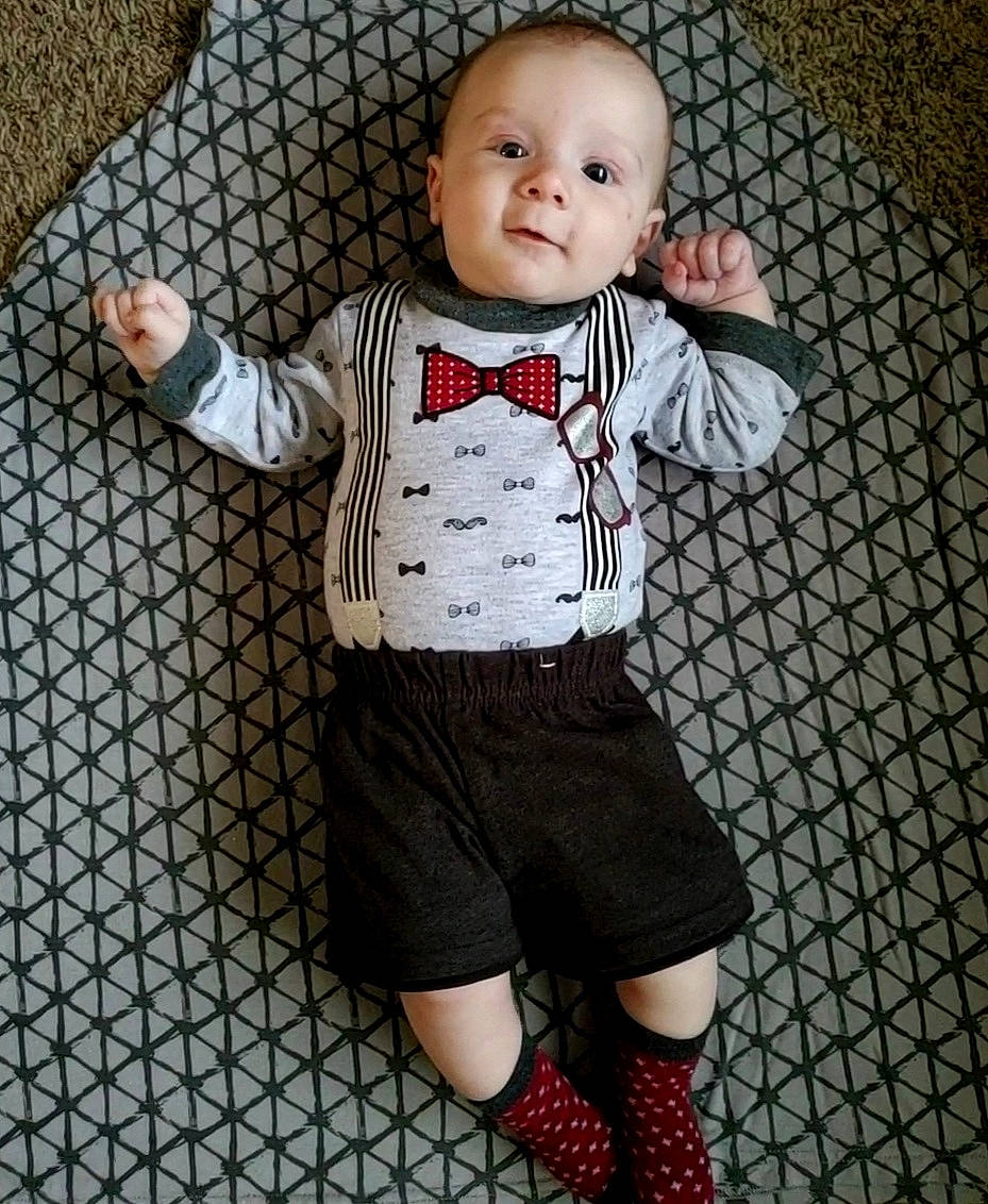 Oliver is registered to the contest to win money with this photo: baby, baby_toddler_clothing, collar, fashion, flooring, happy, human_leg, joint, knee, outerwear, pattern, person, shorts, sleeve, smile, sock, t_shirt, thigh, toddler, toy