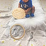 Amari is registered to the contest to win money with this photo: baby, infant, milestone_blanket, wooden_floor, blue_clothing, socks, wooden_sign, hello_world, months, numbers, indoor, child, cute, portrait, flooring, plush_blanket, sitting, young_child, person, baby_milestone