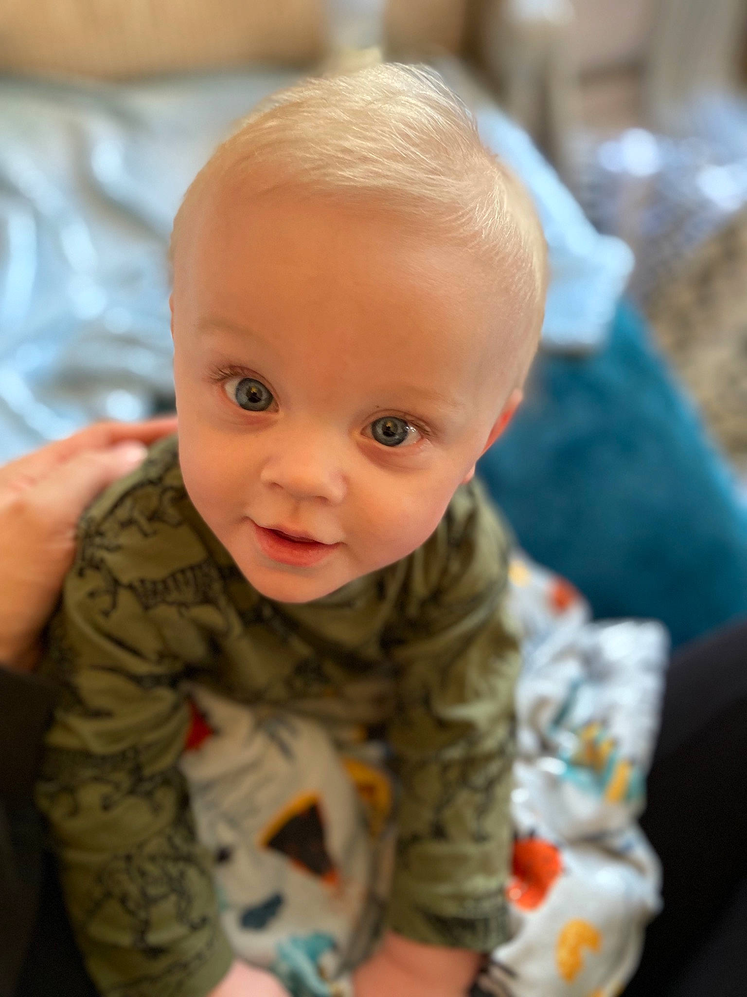 Tyler is registered to the contest to win money with this photo: baby, baby_toddler_clothing, cheek, child, chin, comfort, eye, eyebrow, flooring, fun, hair, head, human_body, iris, nose, person, sitting, skin, sleeve, smile