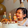 baby, birthday, cake, candle, celebration, child, party_hat, smile, happy, highchair, indoor, food, cookies, decorations, balloons, bunting, cream, icing, first_birthday, person