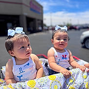 Mykenna is registered to the contest to win money with this photo: baby, blue_sky, blurred_background, bow, car, child, cute, daylight, happy, outdoor, parking_lot, patterned_clothing, shopping_cart, store, stroller, summer, sunny, toddler, two_children, white_tank_top