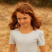 Rose a rejoint le concours — aidez-le/la à gagner de superbes lots ! bow, candid, child, curly_hair, dress, earring, eyes, face, field, freckles, girl, nature, outdoor, playful, portrait, red_hair, smirk, summer, windblown, youth