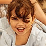 Capucine a rejoint le concours — aidez-le/la à gagner de superbes lots ! brown_hair, candid, child, close_up, curly_hair, dress, earring, eyes, face, happy, laughing, natural_light, outdoor, pale_blue_dress, playful, portrait, skin, smiling_child, teeth, young_person