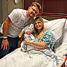 Sutton joined the competition — help win amazing prizes! newborn, baby, mother, father, hospital_bed, hospital_gown, swaddled, family, smiling, indoor, medical, parenthood, love, tenderness, celebration, person, bed, blanket, glasses, tattoo