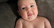 Sutton is registered to the contest to win money with this photo: baby, infant, child, blue_eyes, bare_chest, couch, soft_furniture, skin, tongue_out, cute, portrait, indoors, relaxed, closeup, plump, happy, expression, person, seat, home