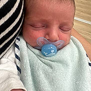 Owenn participe au concours pour gagner de l'argent avec cette photo : arm, baby, child, closeup, comfort, cuddle, face, hand, indoor, infant, newborn, pacifier, peaceful, person, rest, skin, sleeping, soft, striped_clothing, towel