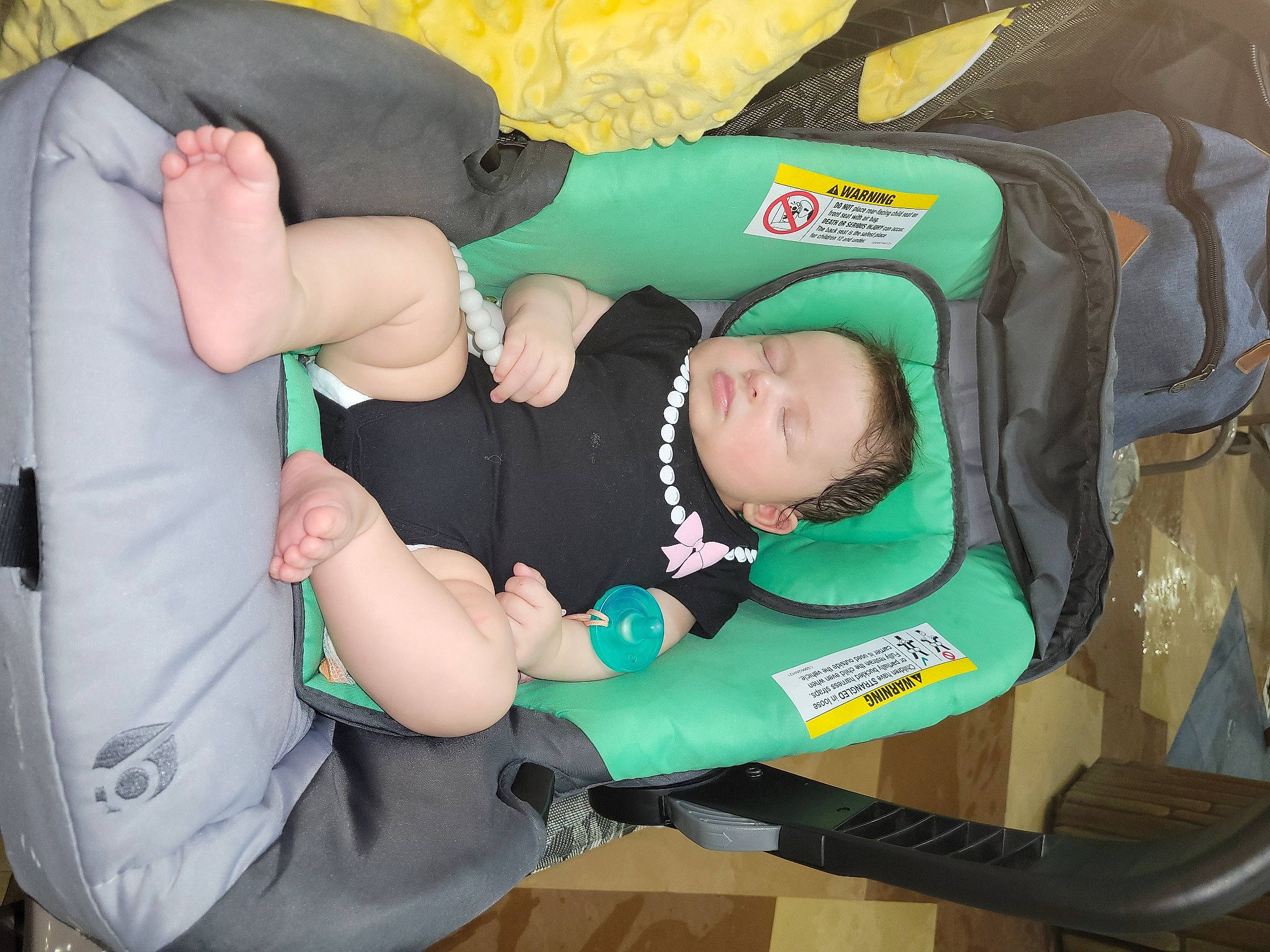 Emberly joined the competition — help win amazing prizes! baby, baby_carriage, baby_products, baby_toddler_clothing, bag, chair, child, comfort, green, lap, person, sitting, sock, toddler