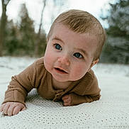Jason joined the competition — help win amazing prizes! baby, infant, child, blue_eyes, brown_sweater, knitted_blanket, outdoor, winter, trees, nature, portrait, cute, curious, face, skin, hands, closeup, crawling, soft_light, background_blur