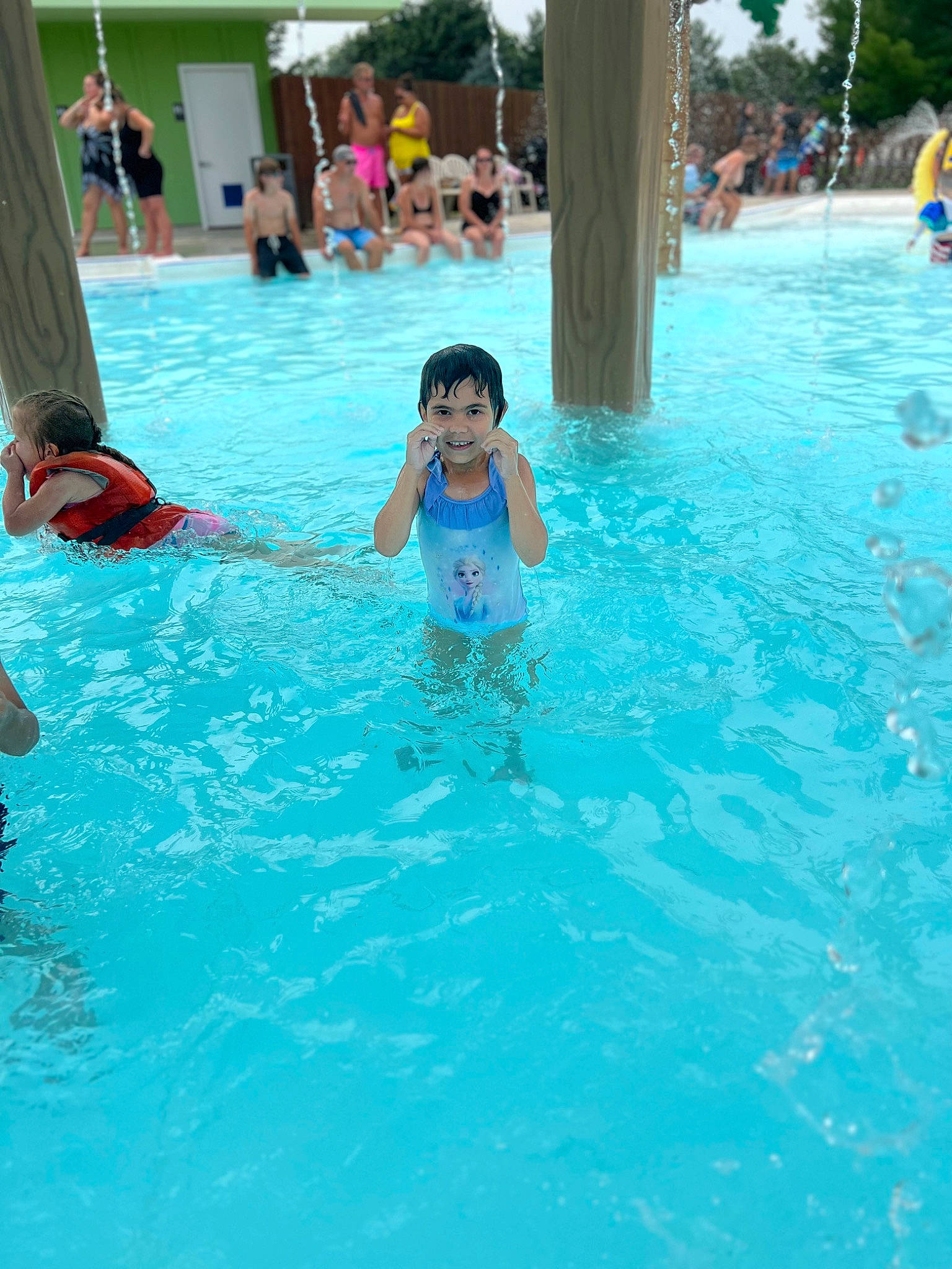 Jasmine is registered to the contest to win money with this photo: amusement_park, bathing, chest, composite_material, event, fun, joy, leisure, leisure_centre, nonbuilding_structure, one_piece_swimsuit, person, personal_protective_equipment, recreation, resort_town, sports, swimming_pool, swimwear, toddler, vacation