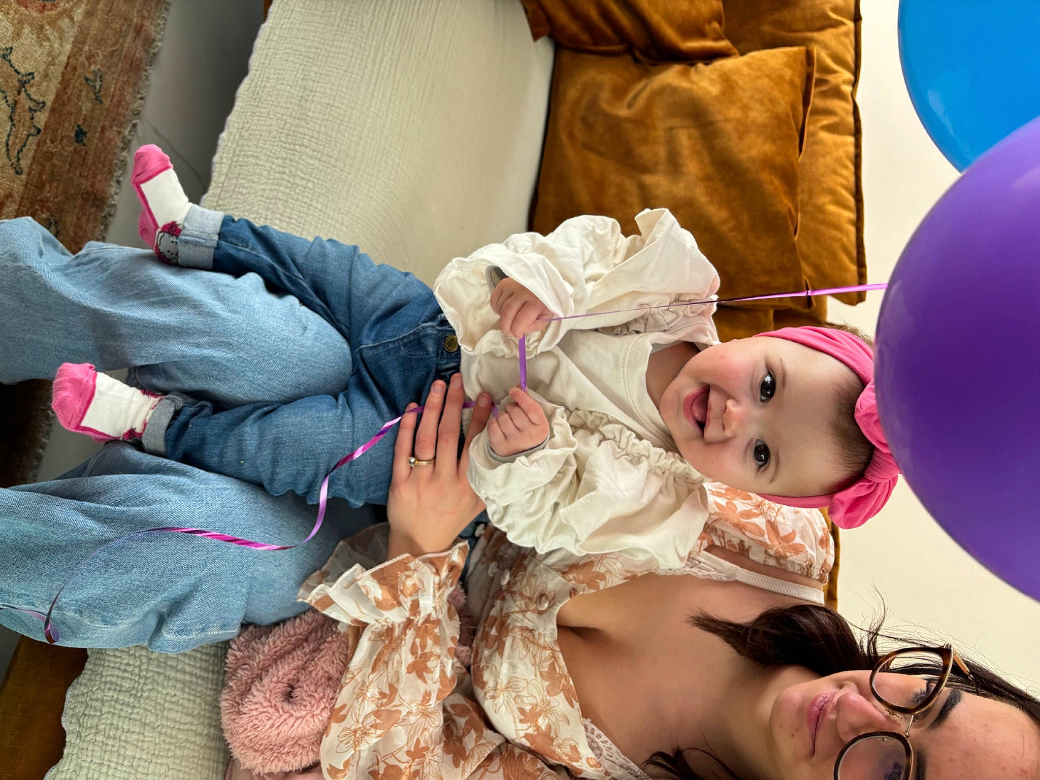 Elya participe au concours pour gagner de l'argent avec cette photo : baby, baby_toddler_clothing, balloon, cheek, child, comfort, event, fun, happy, hat, joy, lap, leisure, magenta, nail, party_supply, person, pink, room, sitting