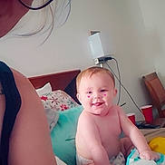 Renezmae joined the competition — help win amazing prizes! baby, diaper, smile, person, adult, glasses, bed, pillow, wipes, room, chair, cup, wall, device, hair, face, skin, indoor, furniture, candid