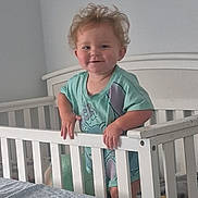 Renezmae joined the competition — help win amazing prizes! toddler, child, crib, bedroom, white_crib, smiling, blonde_hair, tousled_hair, standing, gripping, railing, indoor, bed, blanket, plush_toy, light_wall, casual_clothing, cute, happy, infant