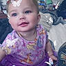 Renezmae is registered to the contest to win money with this photo: child, toddler, baby, dress, purple, butterflies, sparkles, indoor, smiling, blue_eyes, cute, playful, sitting, clothing, face, hair, toy, background, furniture, earrings