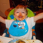 Lancer joined the competition — help win amazing prizes! arms, bib, chair, child, clothing, corn, dining, face, food, happy, highchair, indoor, kid, meal, messy, plate, smiling, spoon, table, toddler