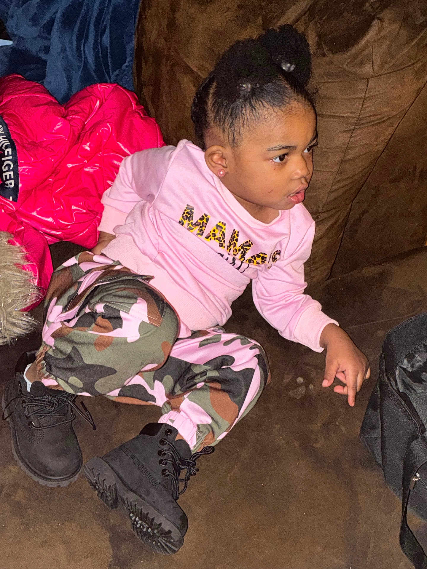 Monika joined the competition — help win amazing prizes! child, girl, couch, pink_sweatshirt, camouflage_pants, black_boots, red_jacket, brown_furniture, indoor, casual_clothing, sitting, curious_expression, hairstyle, earrings, bag, floor, cozy, young, portrait, person