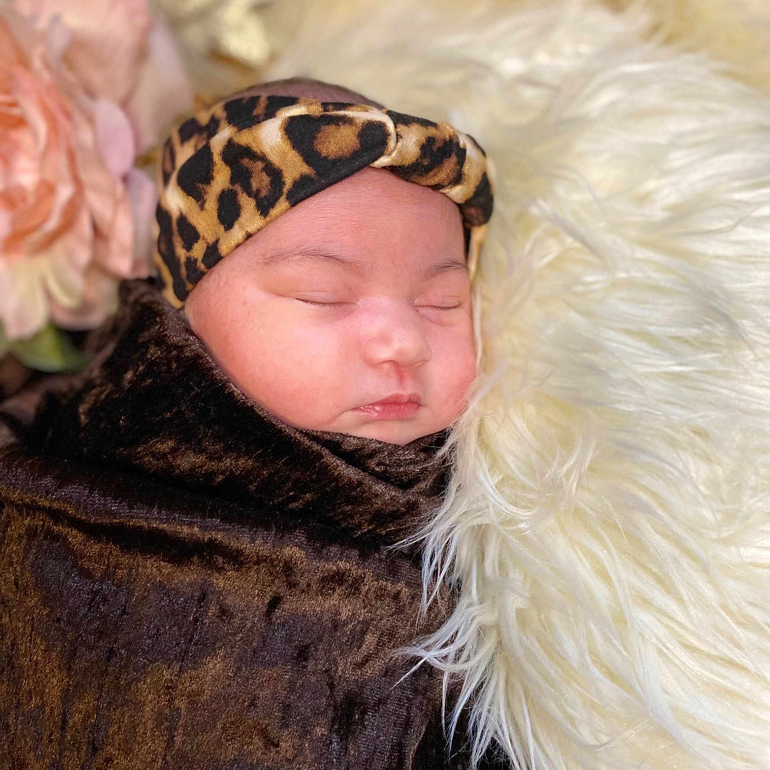 Raya is registered to the contest to win money with this photo: animal_product, baby, beanie, brown_hair, cap, fashion_accessory, feather, flower, fur, fur_clothing, hair_accessory, happy, headgear, headpiece, jacket, peach, petal, rose, textile, wool