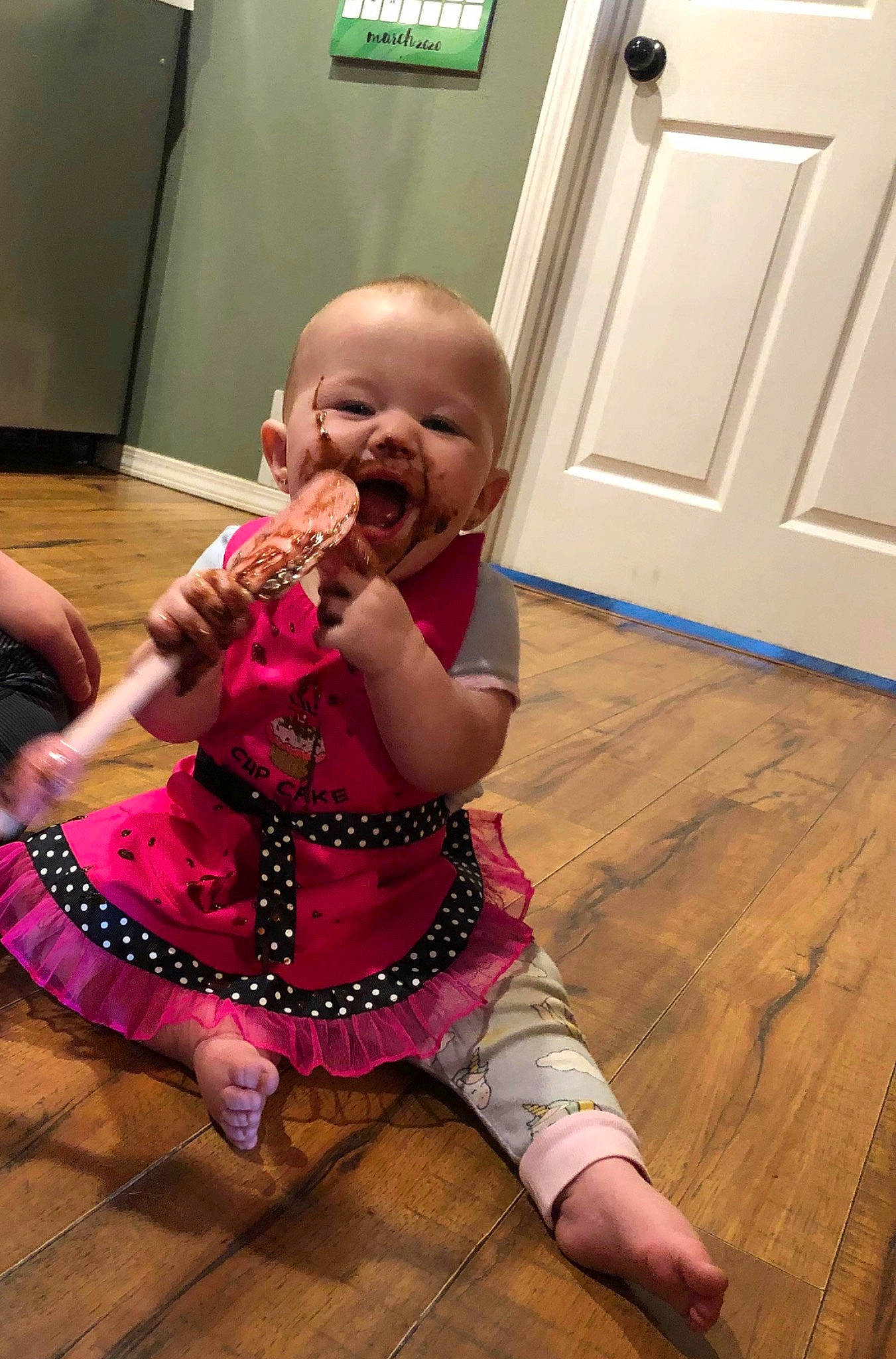 Kimberley joined the competition — help win amazing prizes! baby, child, floor, flooring, hardwood, leg, person, sitting, smile, thumb, toddler, wood