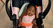 Legacy joined the competition — help win amazing prizes! adorable, baby, baby_gear, car_seat, child, concrete_floor, curly_hair, indoors, infant, looking_at_camera, orange_bow, pink_clothing, portrait, safe, sitting, smiling, striped_outfit, stroller, tongue_out, white_shoes