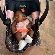 Legacy is registered to the contest to win money with this photo: adult_knee, baby, car_seat, concrete, curly_hair, cute, face, fashion, infant, lying_down, orange_bow, outdoor, photography, pink_clothing, portrait, sitting, striped_outfit, stroller, transportation, white_shoes