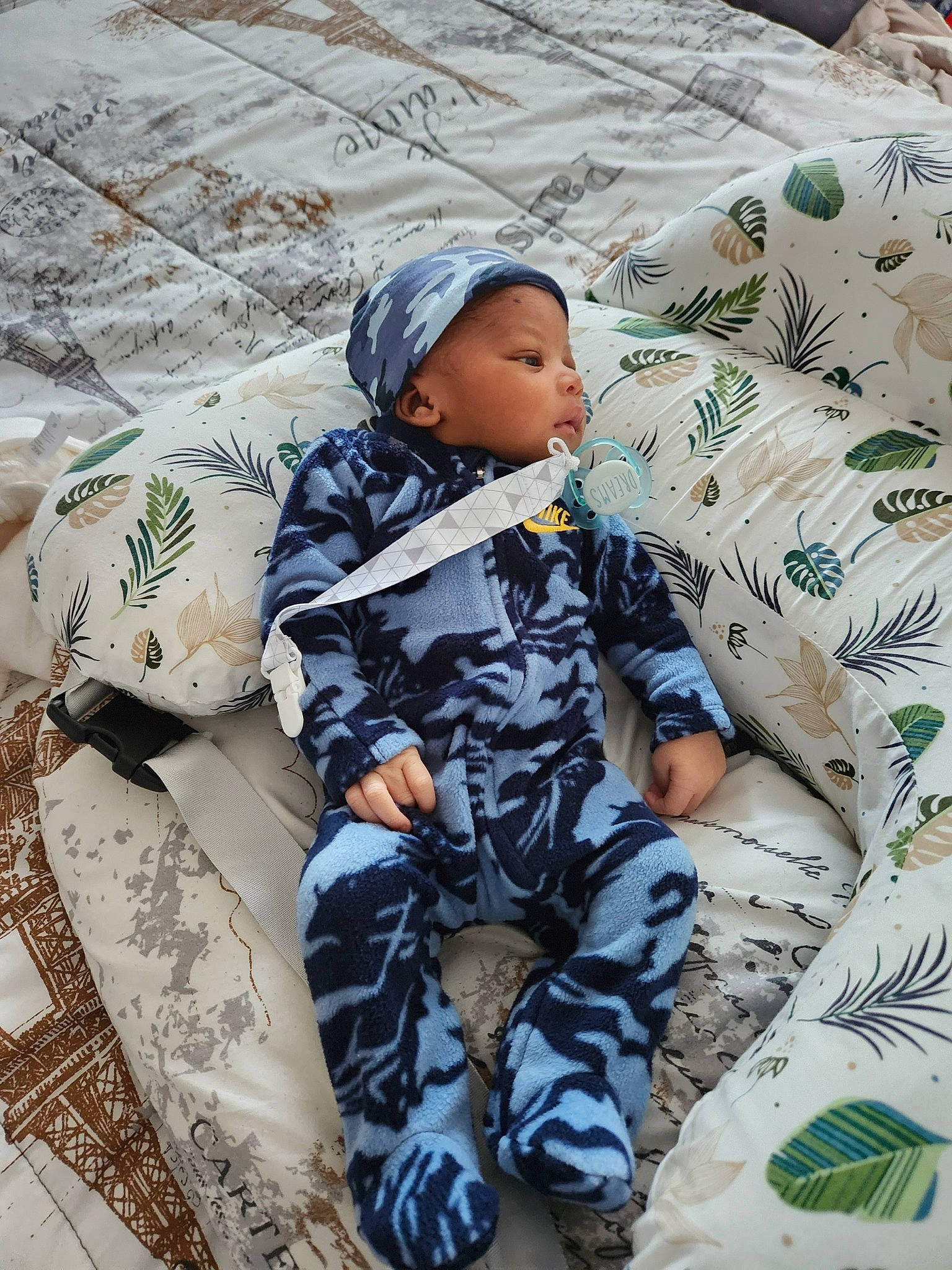 Landon is registered to the contest to win money with this photo: baby, baby_products, baby_toddler_clothing, bedding, child, comfort, headwear, linens, mammal, military_camouflage, pattern, person, room, sitting, sleep, sleeve, t_shirt, textile, thigh, toddler