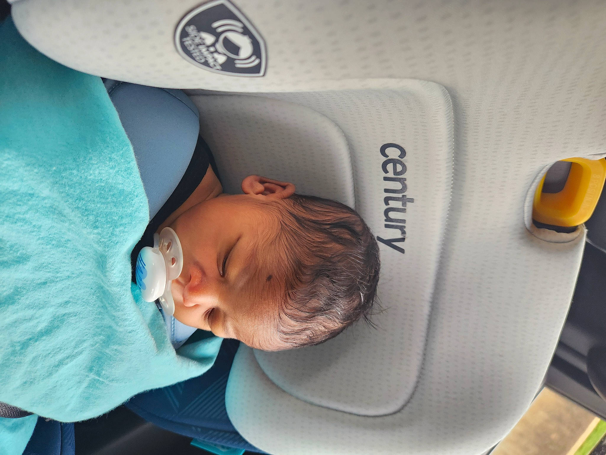 Landon is registered to the contest to win money with this photo: auto_part, automotive_design, baby, baby_products, baby_safety, baby_sleeping, baseball_cap, car_seat, child, comfort, hat, home_appliance, linens, nap, person, product, room, service, sleep, toddler