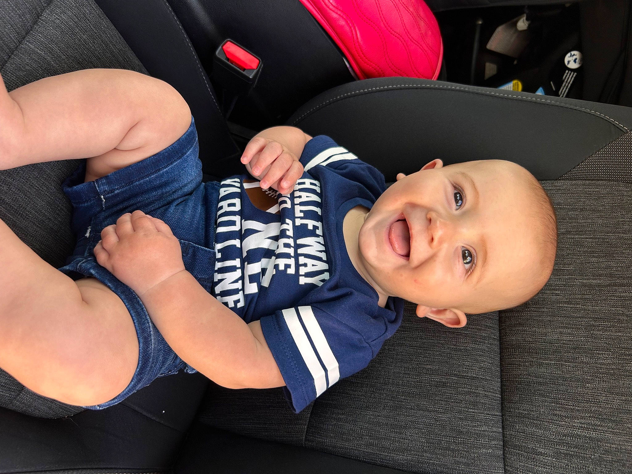 Jay is registered to the contest to win money with this photo: auto_part, baby, baby_toddler_clothing, car_seat, chest, child, comfort, elbow, electric_blue, finger, fun, gesture, happy, human_leg, knee, lap, person, smile, thigh, toddler