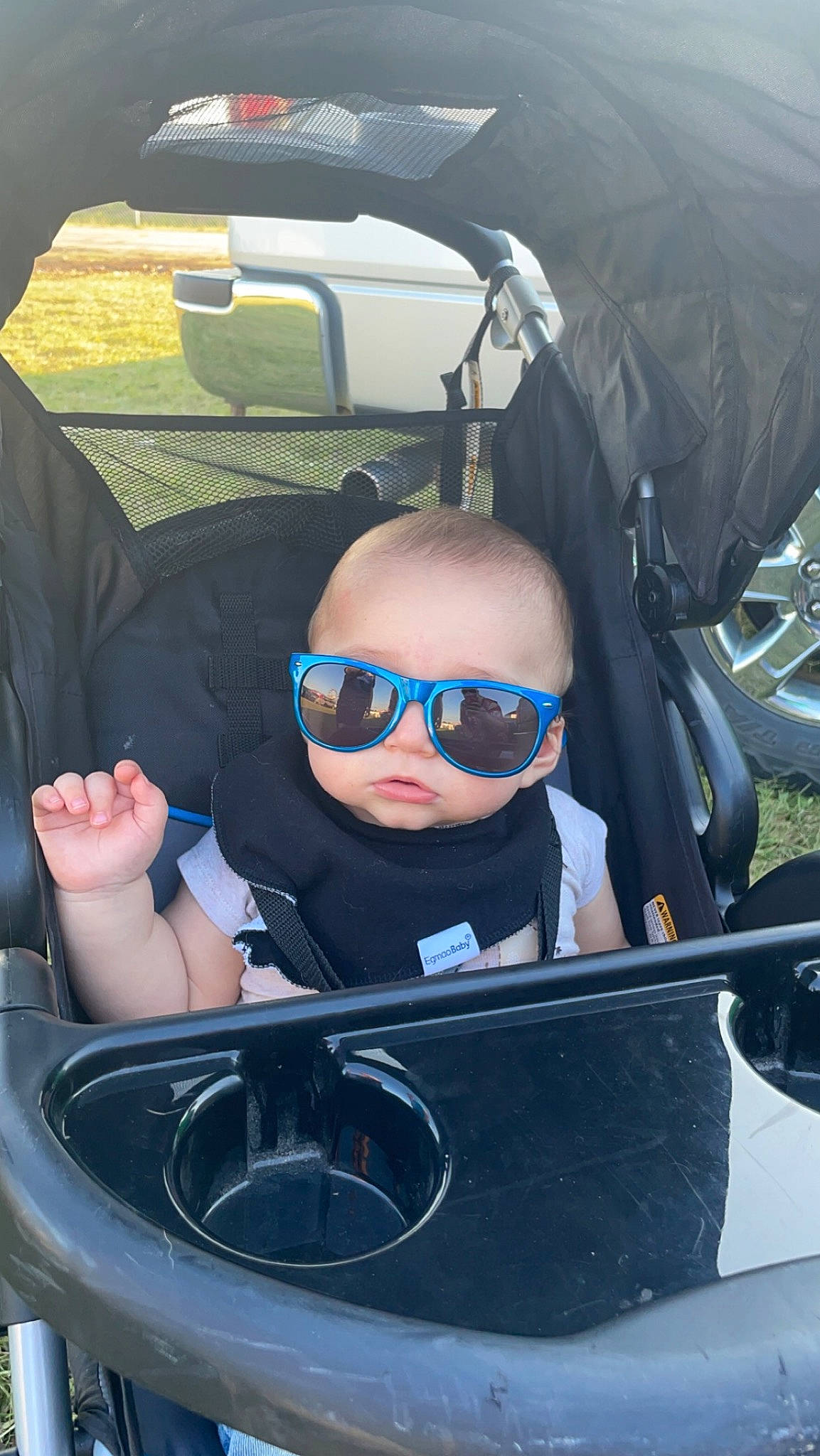 Jay is registered to the contest to win money with this photo: auto_part, automotive_design, automotive_exterior, automotive_mirror, bumper, car_seat, car_seat_cover, comfort, eyewear, goggles, hood, mode_of_transport, motor_vehicle, person, steering_part, steering_wheel, sunglasses, toddler, vehicle_door, vision_care