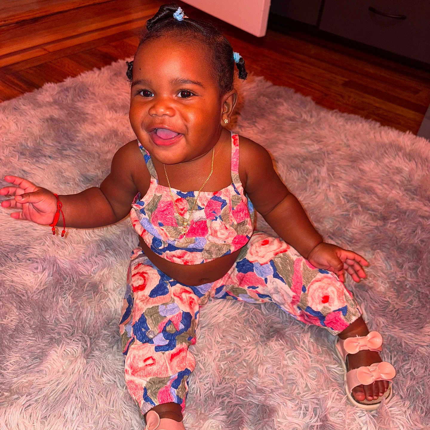 Riel joined the competition — help win amazing prizes! braided_hair, child, colorful_clothing, cute, door, drawer, earrings, happy, indoor, jewelry, necklace, person, plush_rug, portrait, red_bracelet, sandals, sitting, smiling, toddler, wooden_floor