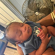 Kyzir is registered to the contest to win money with this photo: baby, sleeping, infant, person, hand, clothing, mickey_mouse, fan, arm, indoor, floor, wood, skin, hair, cute, peaceful, child, holding, portrait, relaxing