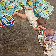 Sebastian joined the competition — help win amazing prizes! babies, baby_clothes, blanket, board_book, carpet, children, colorful, crawling, family, floor, indoor, infants, nursery, overhead_view, play_mat, playing, playtime, spongebob, toys, tummy_time