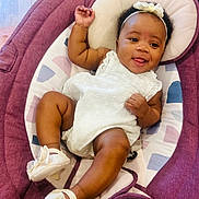 Sevyn joined the competition — help win amazing prizes! baby, infant, child, smiling, white_dress, headband, baby_shoes, purple_baby_seat, cushion, indoor, cute, happy, playful, tongue_out, relaxing, person, portrait, young_child, fashion, accessory