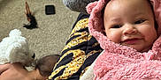 Melody joined the competition — help win amazing prizes! baby, child, toddler, pink_hoodie, smile, carpet, indoor, person, plush, hand, furniture, clothing, room, toy, box, crawling, skin, head, hair, cozy
