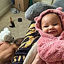 baby, child, toddler, pink_hoodie, smile, carpet, indoor, person, plush, hand, furniture, clothing, room, toy, box, crawling, skin, head, hair, cozy