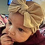 Melody is registered to the contest to win money with this photo: baby, child, headband, bow, face, hand, fingers, clothing, blanket, indoor, portrait, cute, infant, closeup, expression, person, skin, eyes, head, gaze