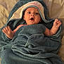 Joey is registered to the contest to win money with this photo: baby, child, towel, blue, shark, bed, blanket, cute, expression, face, infant, wrapped, soft, hands, eyes, mouth, indoors, person, smile, comfort