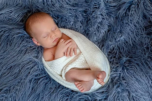Tyler is registered to the contest to win money with this photo: baby, baby_sleeping, baby_toddler_clothing, child, comfort, event, eye, finger, fur, grass, linens, pattern, person, portrait_photography, sitting, skin, textile, toddler, tree, wood