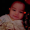 Liam is registered to the contest to win money with this photo: baby, blanket, child, closeup, cozy, cute, dark_background, face, happy, head, heart_effects, indoors, infant, person, portrait, smile, soft_lighting, warm, wrapped, young