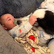 Liam is registered to the contest to win money with this photo: animal, baby, blanket, child, clothing, comfort, cozy, cuddle, cute, dog, face, fur, indoor, infant, love, pacifier, pet, resting, soft, toddler