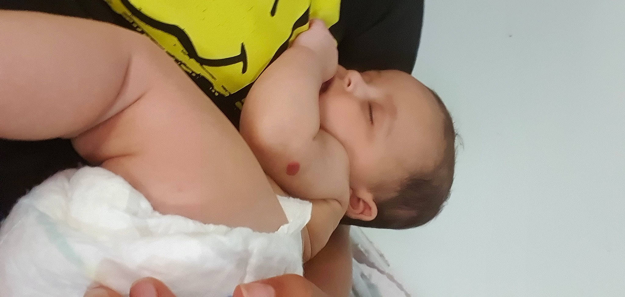 Aurelia is registered to the contest to win money with this photo: abdomen, baby, baby_sleeping, baby_toddler_clothing, cheek, chest, child, comfort, eye, eyelash, face, fashion_accessory, finger, gesture, happy, mouth, pattern, person, skin, thumb