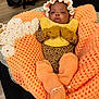 Tazori joined the competition — help win amazing prizes! baby, infant, blanket, knitwear, mittens, booties, bib, leopard_print, orange, yellow, sleepy, cute, cozy, indoor, person, child, headwear, soft, warm, resting