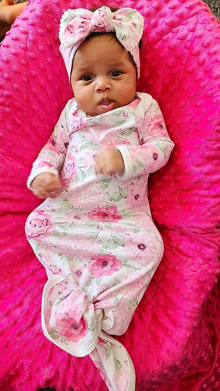 Xavianna is registered to the contest to win money with this photo: baby, baby_products, baby_sleeping, baby_toddler_clothing, beauty, bedding, child, comfort, dress, happy, headwear, linens, magenta, pattern, person, pink, purple, sitting, skin, sleeve