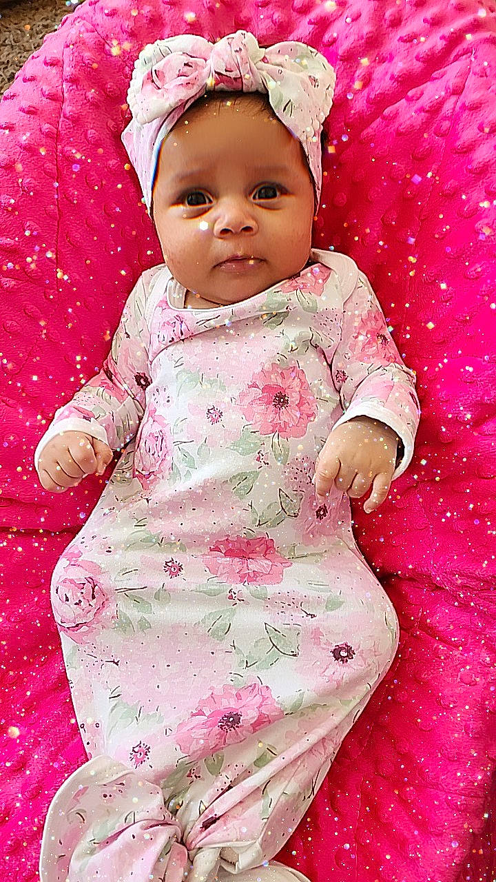 Xavianna is registered to the contest to win money with this photo: arm, baby, baby_products, baby_toddler_clothing, beauty, cap, cheek, child, dress, face, happy, headwear, magenta, pattern, people_in_nature, person, pink, purple, skin, sleeve