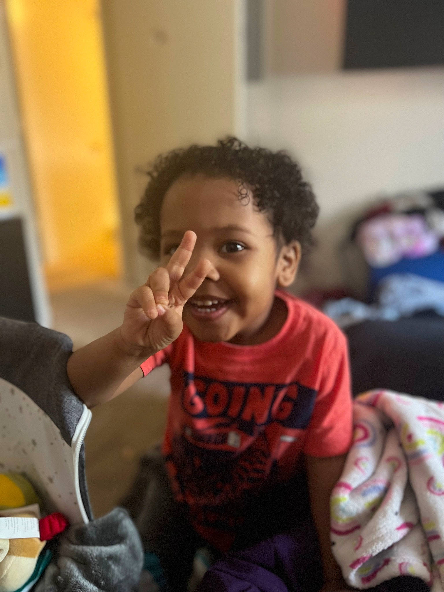 Roman is registered to the contest to win money with this photo: baby, baby_toddler_clothing, chair, cheek, child, comfort, event, finger, fun, gesture, happy, joy, laugh, person, room, sitting, skin, smile, t_shirt, thumb