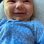 Ryker is registered to the contest to win money with this photo: baby, smile, face, clothing, blue, onesie, infant, cheeks, expression, happy, portrait, child, cute, young, soft, pattern, fabric, closeup, person, sitting