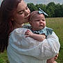 Ryker is registered to the contest to win money with this photo: woman, baby, field, outdoor, nature, greenery, sky, clouds, dress, headband, holding, affection, love, portrait, person, child, happy, tender, clothing, face