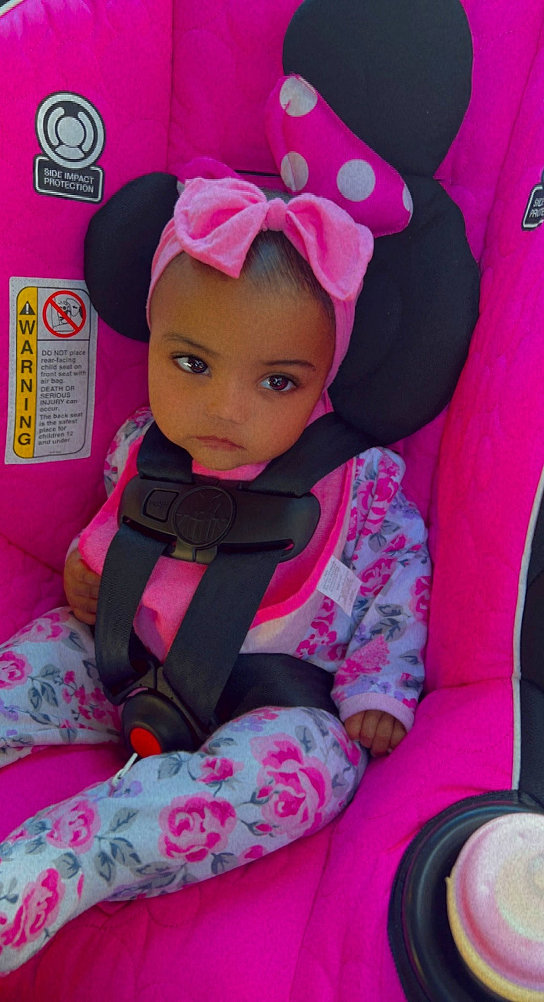 Mariah is registered to the contest to win money with this photo: baby, baby_products, baby_toddler_clothing, cap, car_seat, cheek, child, comfort, eye, fashion_accessory, head, magenta, pattern, person, pink, product, purple, sleeve, tableware, toddler