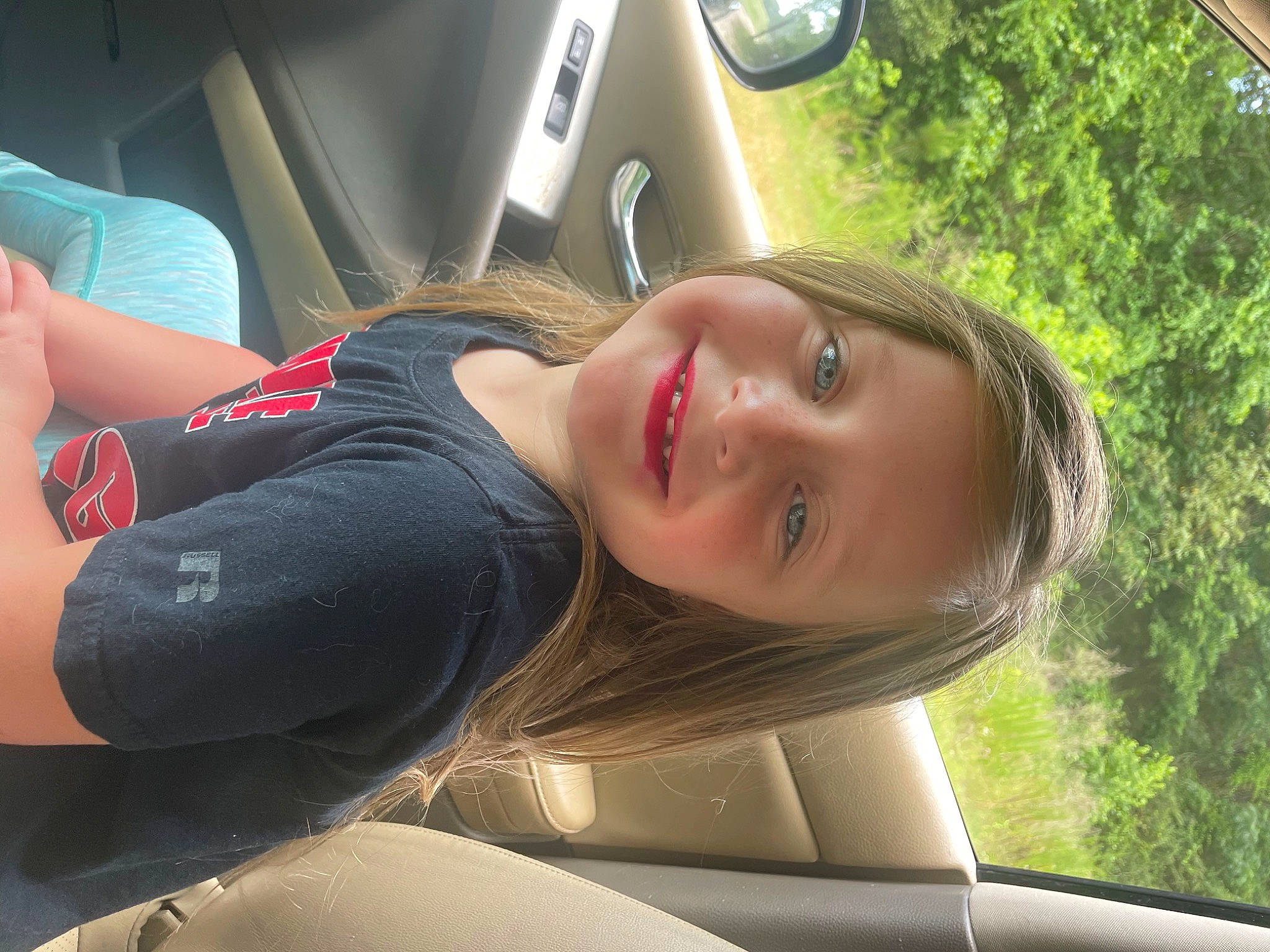 Scarlett is registered to the contest to win money with this photo: auto_part, automotive_design, automotive_exterior, automotive_lighting, automotive_tire, car, comfort, eyewear, flash_photography, grass, joy, leisure, motor_vehicle, person, personal_luxury_car, plant, smile, steering_wheel, tree, vehicle