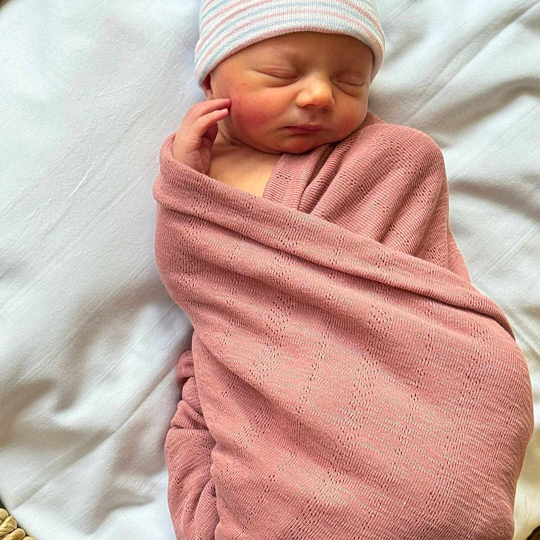 Julia joined the competition — help win amazing prizes! baby, basket, blanket, closeup, cozy, cute, face, hand, hat, indoors, infant, newborn, peaceful, pink, portrait, resting, sleeping, soft_texture, white_cloth, wrapped