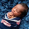 baby, blanket, blue, child, closeup, cozy, cute, face, floral, hands, infant, newborn, peaceful, portrait, resting, sleeping, soft, texture, warm, wrapped