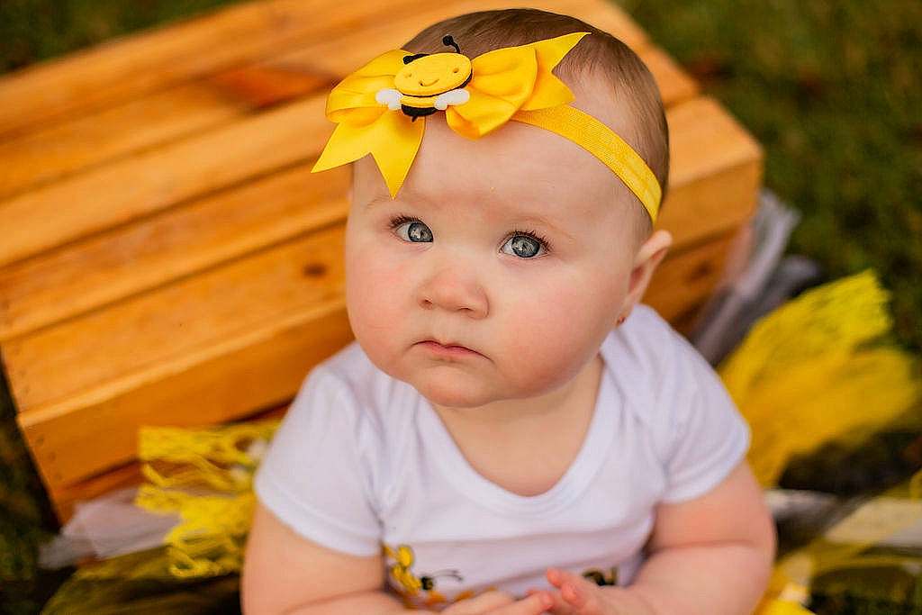 Harleigh is registered to the contest to win money with this photo: baby, baby_toddler_clothing, cap, cheek, child, clothing, finger, fun, grass, happy, headwear, iris, nose, orange, people_in_nature, person, plant, skin, smile, sunglasses